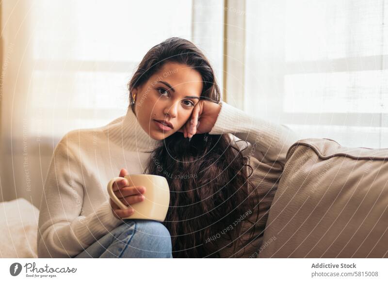 Enjoying Morning at Home: Young Woman Drinking Coffee Relaxation Window Sofa Indoors Cozy Serene Tranquility Comfort Peaceful Lifestyle Contentment Leisure