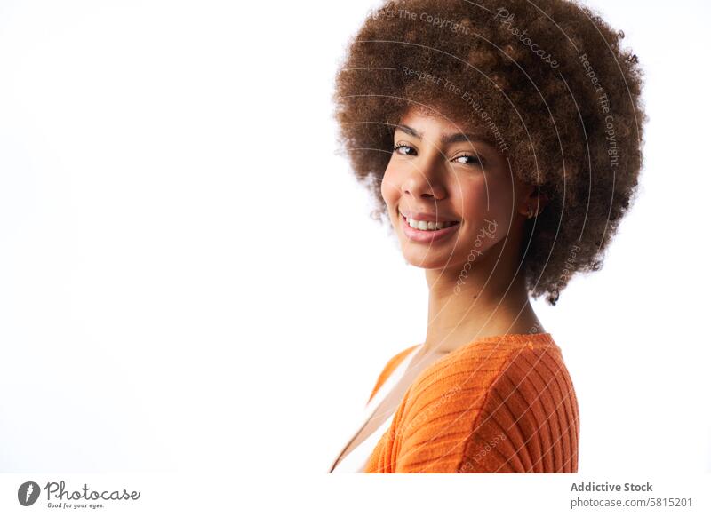 portrait of smiling latina woman with afro hair looking into camera on white background female curly beauty person young african face attractive american adult