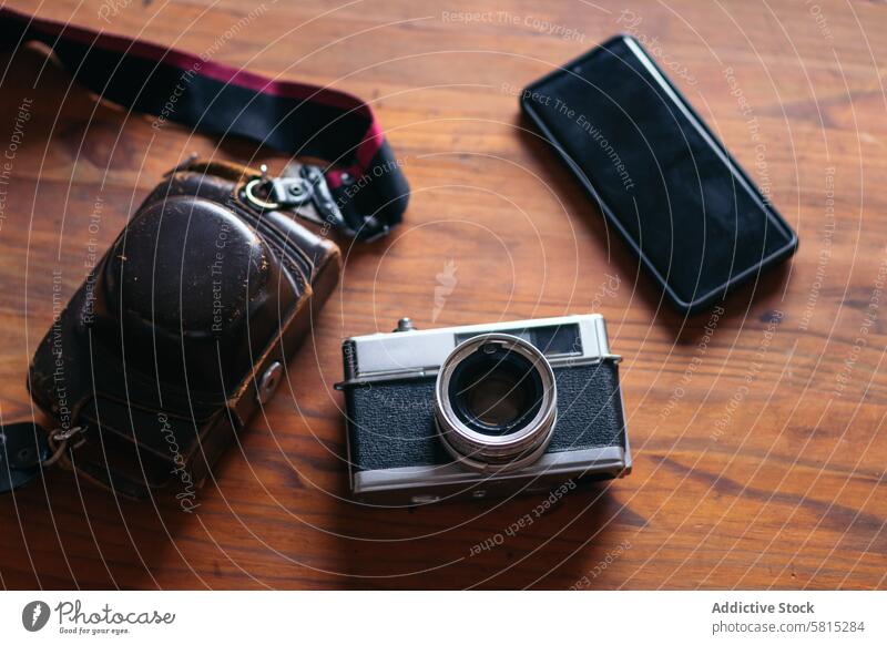 Analog camera and smartphone: old and new technology. photo lifestyle photography vintage retro hipster photographer analog shoot concept hobby photographing