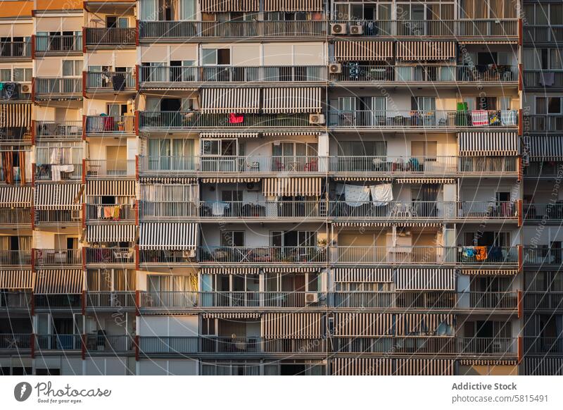 Balconies of apartment building in morning balcony sunlit cloth dry belonging residential exterior street modern town dwell property construction block sunlight