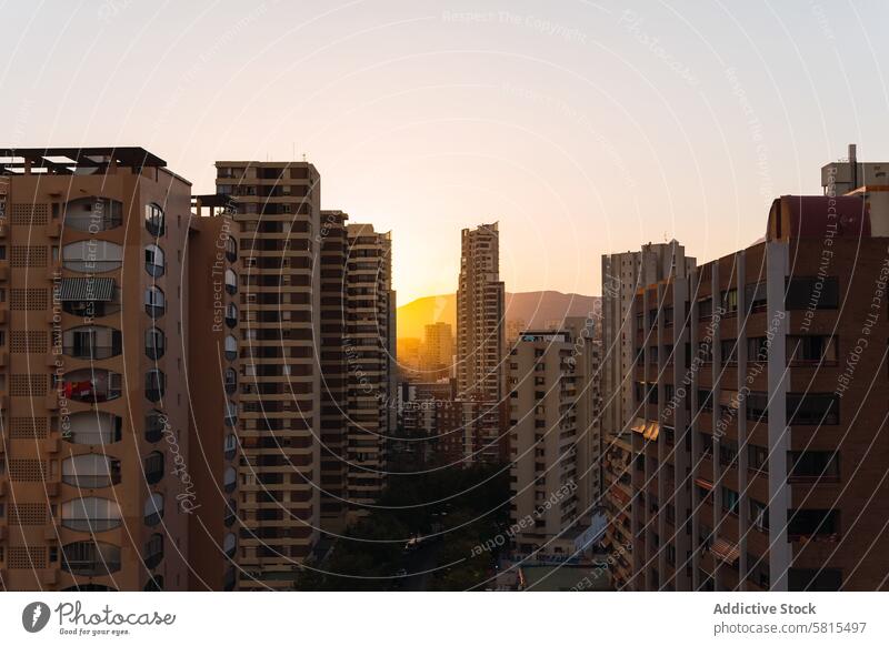 Residential buildings against sunset sky apartment street city modern district architecture urban cityscape twilight dusk sundown construction structure dwell