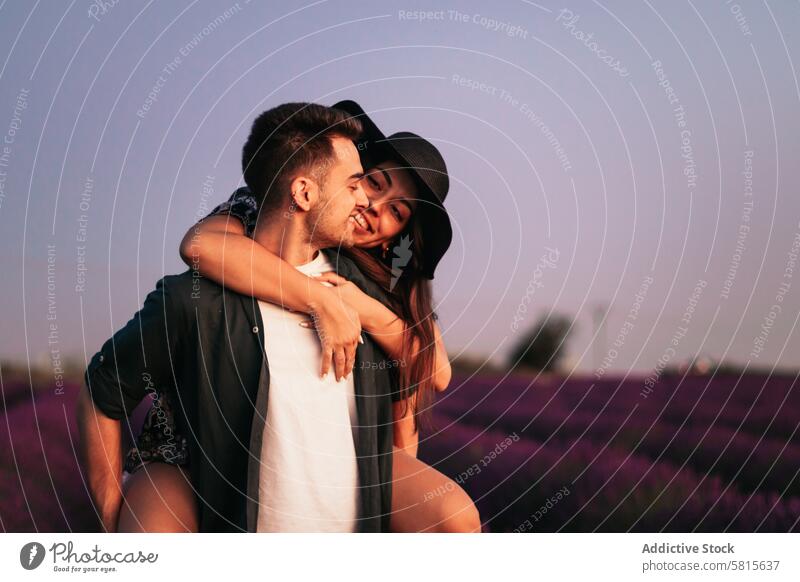 A romantic photograph of a couple in a lavender field sunset love woman summer purple happy together beautiful young nature relationship lifestyle romance