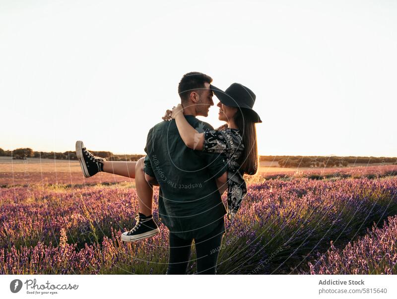 Beautiful romantic photo of a couple in a field of flowers at sunset lavender love woman summer purple happy together beautiful young nature relationship