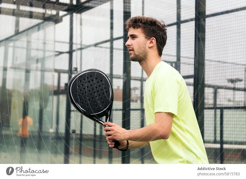 young man ready to play paddle tennis racket game sport recreation court padel serve spanish attractive adult lifestyle ball healthy playing leisure sportsman