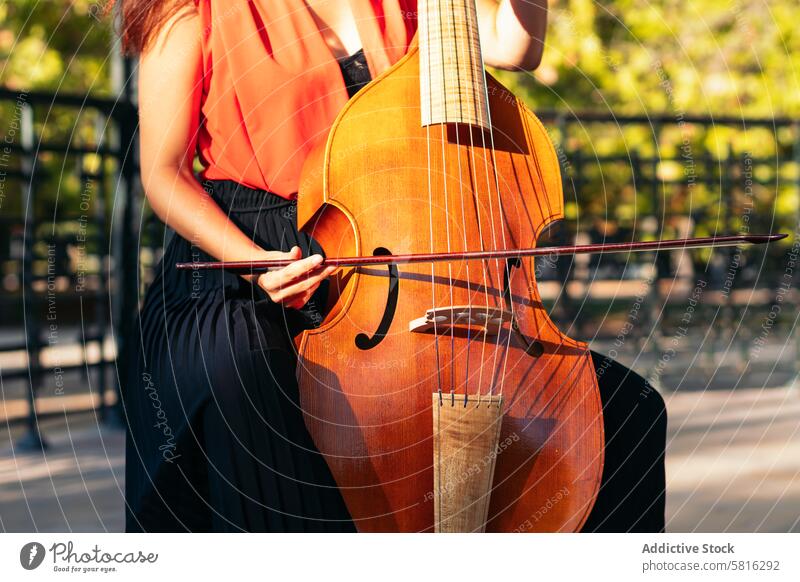Cropped shot of an unrecognizable woman playing the cello outdoors musician instrument concert performance artist musical classical violin violinist