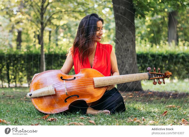 Woman with cello in a park musician woman instrument concert performance artist musical play outdoors classical entertainment orchestra melody symphony sound