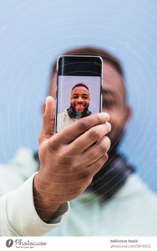 Happy ethnic man taking selfie on smartphone happy hipster cheerful mobile photography using take photo adult black african american male casual device gadget
