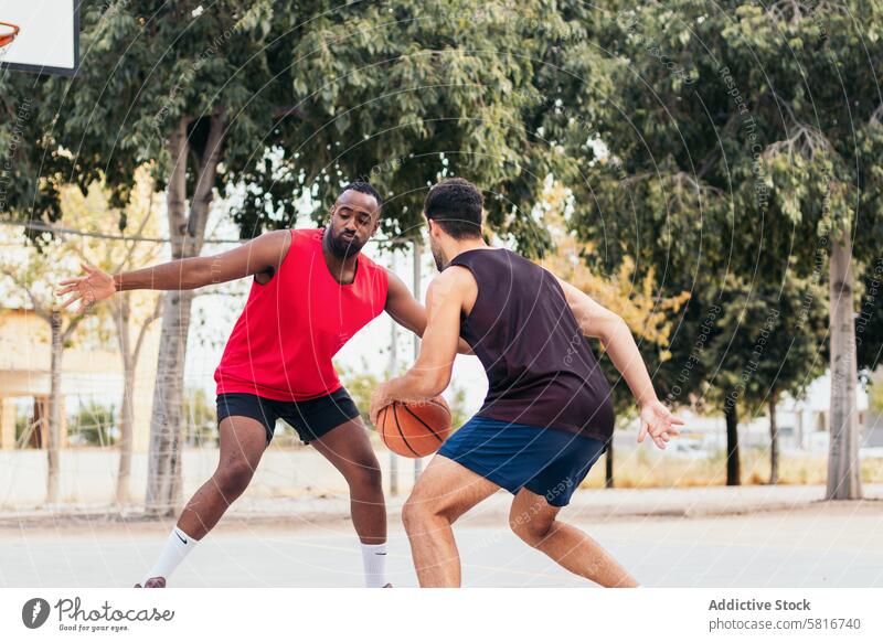 Men Dominating the Basketball Court Multiracial friends basketball game friendship outdoor sports competition teamwork active lifestyle community