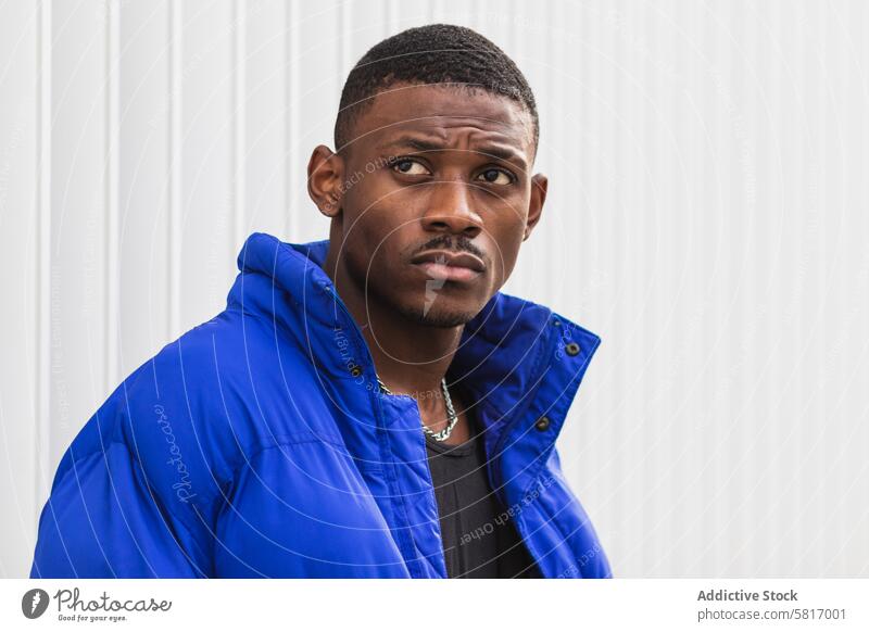 Black stylish man in warm jacket on street style warm clothes handsome outerwear city confident male ethnic black african american vivid blue color fashion