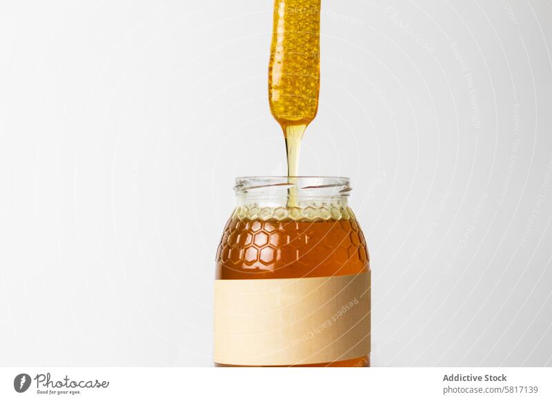 Honey with honeycomb in glass jar natural aromatic sweet healthy food fresh beekeeping delicious organic ingredient tasty treat meal flavor yummy piece product
