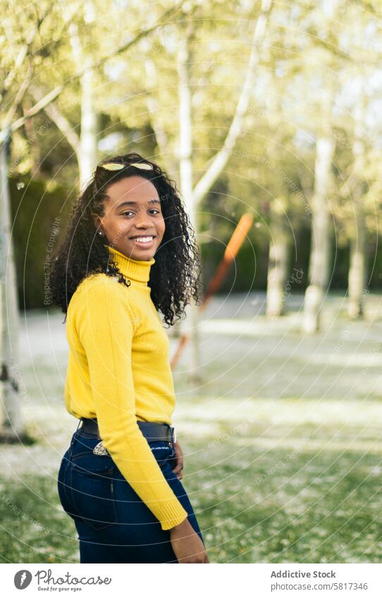black girl portrait smiling in a park african happy cute beautiful outdoor young joy pretty afro people smile person grass green hair outside fun female