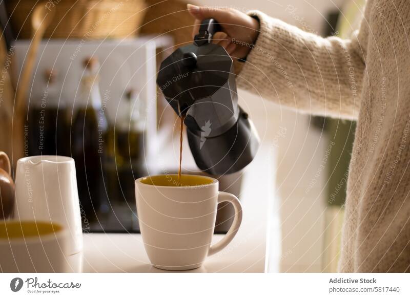 Hand of a woman pouring coffee with an italian coffee maker in a kitchen cup drink hand beverage cafe espresso caffeine hot mug breakfast morning background