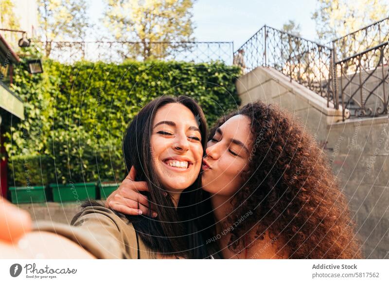 stylish women couple selfie kissing on the cheek woman love portrait young female relationship caucasian together happiness happy attractive people girlfriend
