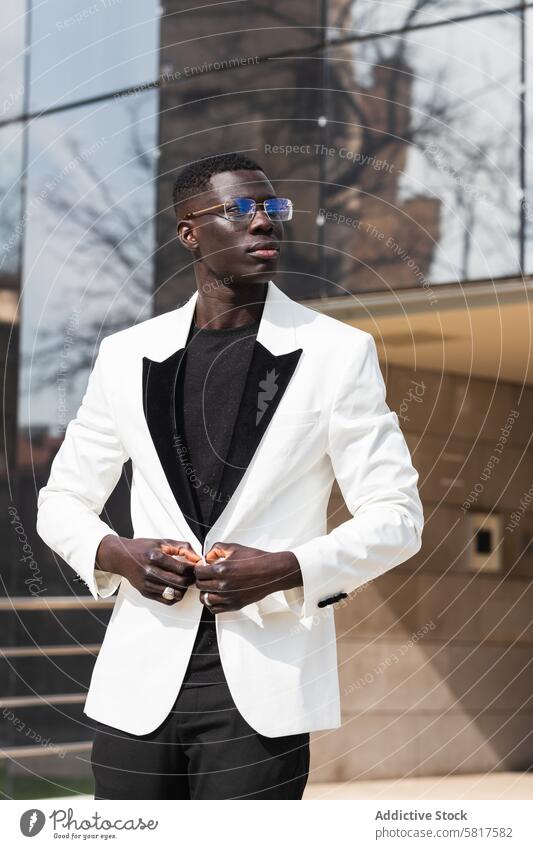 Stylish African American businessman in eyeglasses in town style confident individuality independent masculine macho portrait jacket smart casual city buttoning