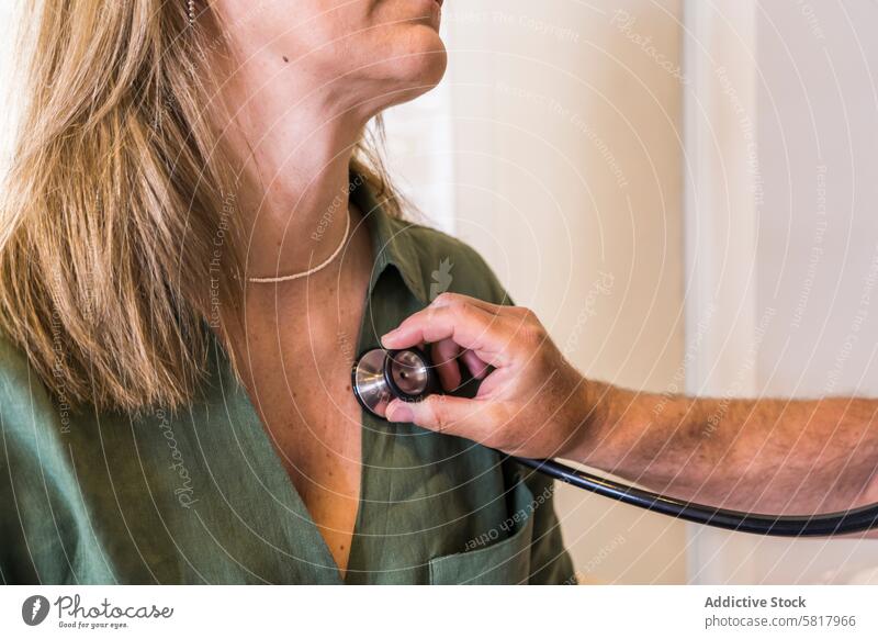 Close-up of a doctor checking her patient's heart beat with stethoscope. Analyzing Healthcare And Medicine Occupation Professional Occupation cardiologic