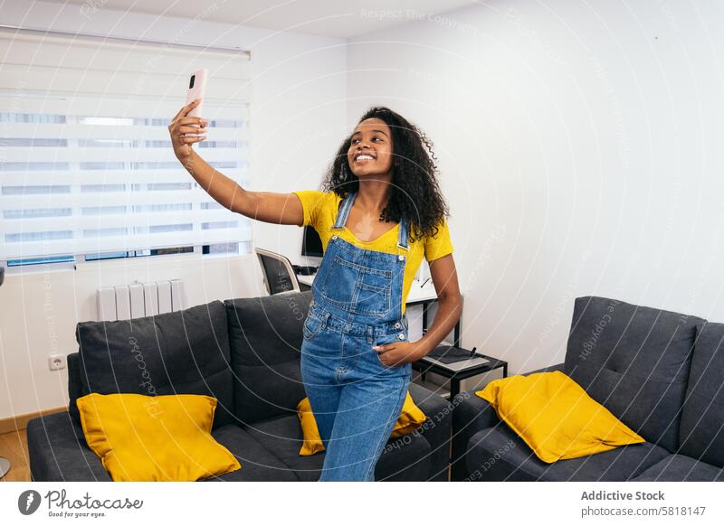 Smiling Selfie: Young Black Woman in Yellow Shirt Black woman Yellow shirt Smartphone Technology Self-expression Happiness Joy Candid Diversity Ethnicity