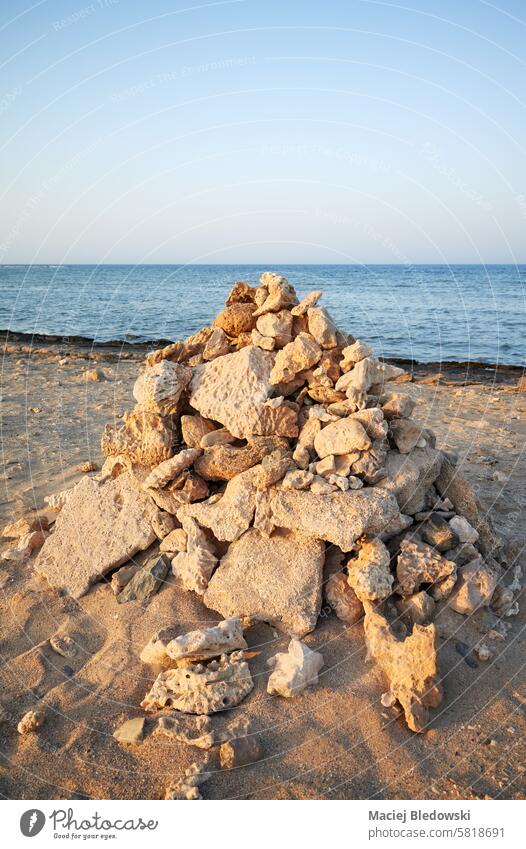 Pyramid of coral and stones on the beach, selective focus, Egypt. pyramid nature sea summer peaceful relax sky ocean natural reef Marsa Alam sand water holidays