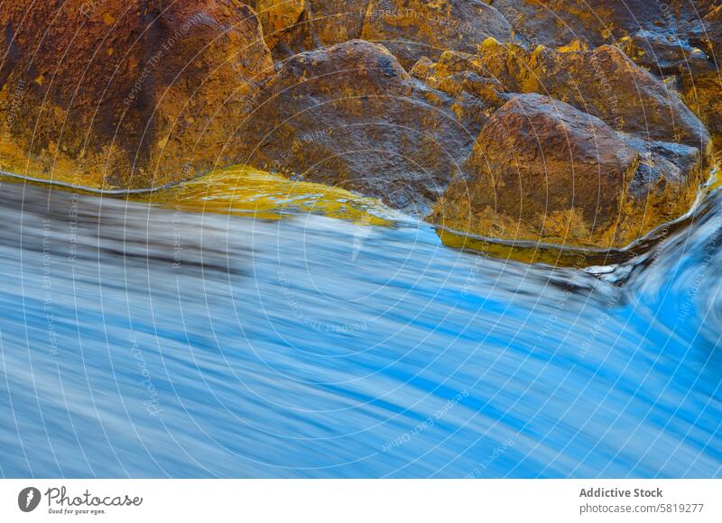 Warm Rocks Against Flowing Water in Rio Tinto landscape intimate rio tinto rocks warm tones water flowing mineral sediments metal contrast white balance cool
