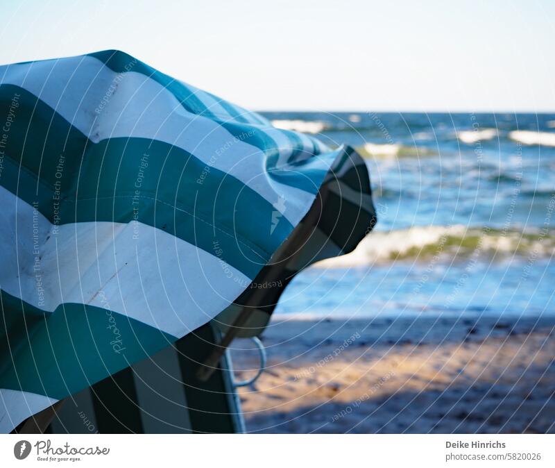 Beach chair on the Baltic Sea beach with focus on green and white striped canopy Summer vacation Nature Strang Sandy beach free time Relaxation Ocean holidays
