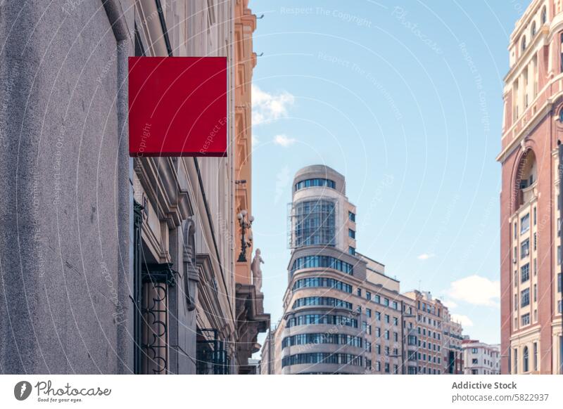 Blank billboard on a sunny Madrid street madrid blank mockup urban advertising sign city architecture building facade sky blue clear day outdoor red wall