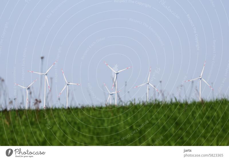 Wind turbines on greenfield sites windmills wind power Renewable energy Energy industry Wind energy plant green meadow Meadow Green Grass