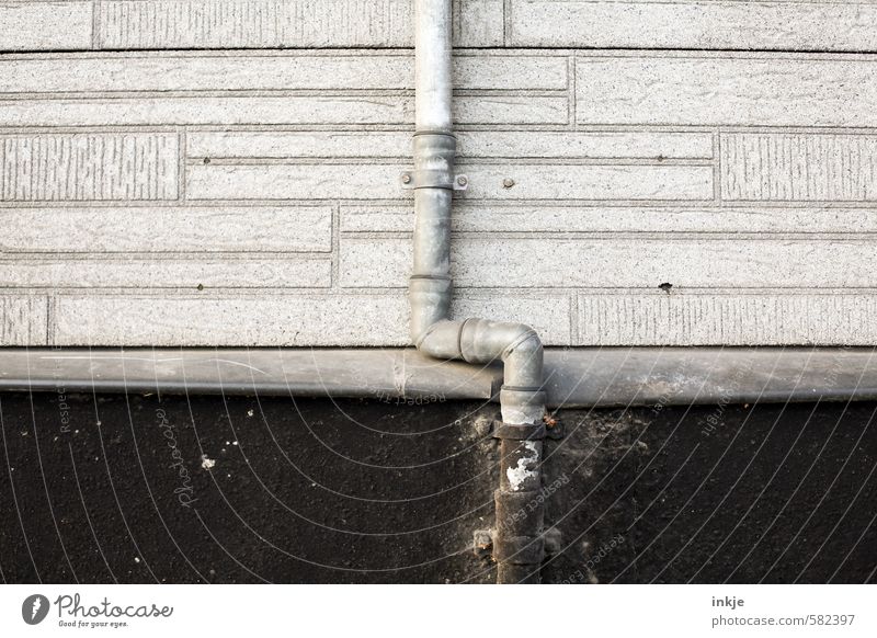 rain pipe Deserted Manmade structures Wall (barrier) Wall (building) Facade Downpipe Thin Long Gray Black Broken Downward Vertical Colour photo Subdued colour