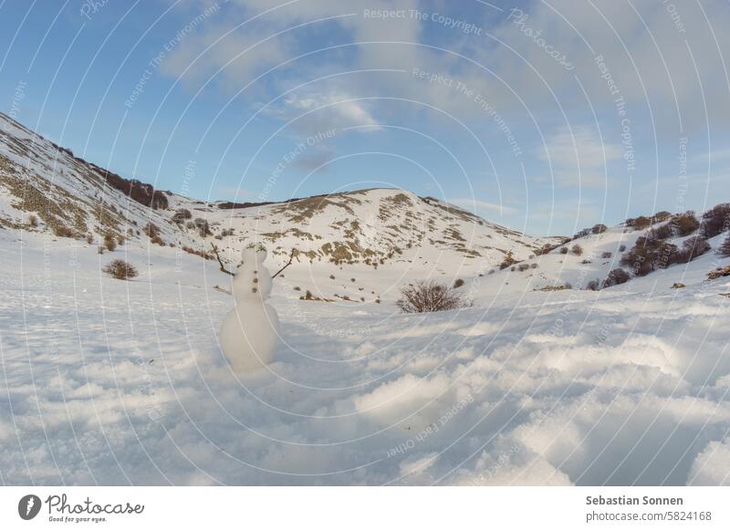 Snowman in front of mountain landscape of Madonie Natural Park in winter covered in snow on a sunny day, Sicily, Italy snowman travel madonie sicily sky tourism
