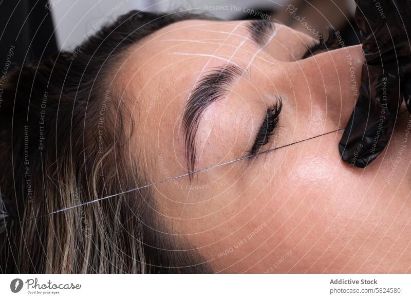 Precision Eyebrow Threading at a Wellness Center wellness center eyebrow threading design precision close-up beauty service treatment facial care grooming
