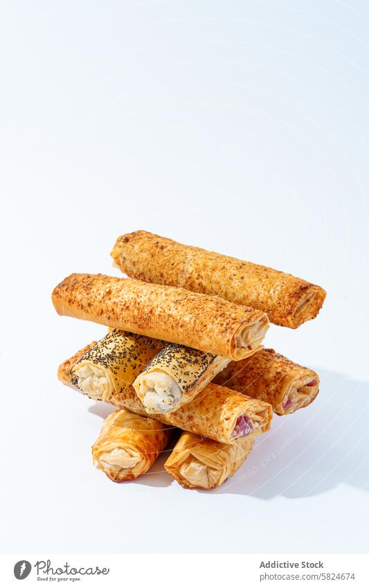Assorted savory puff pastry rolls on white background baked sesame poppy seed white background background fresh assorted variety snack appetizer food flaky