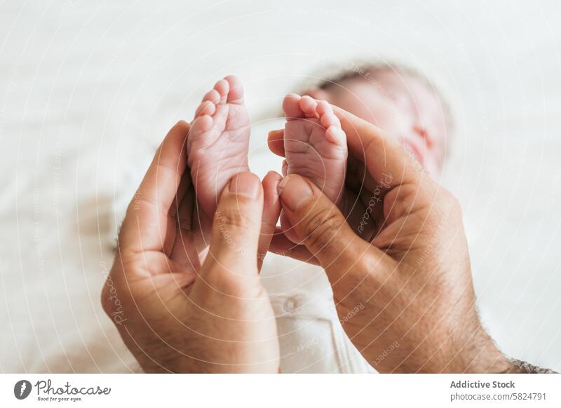 Gentle touch of newborn baby feet in parent's hands gentle care love infant delicate tender portrait child hold soft skin nurture protect small tiny human life