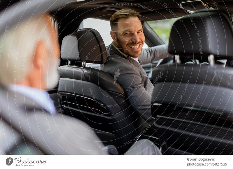 Smiling passenger engaging in friendly conversation with driver inside a modern car vehicle smiling rear seat camaraderie man transport automotive travel seated