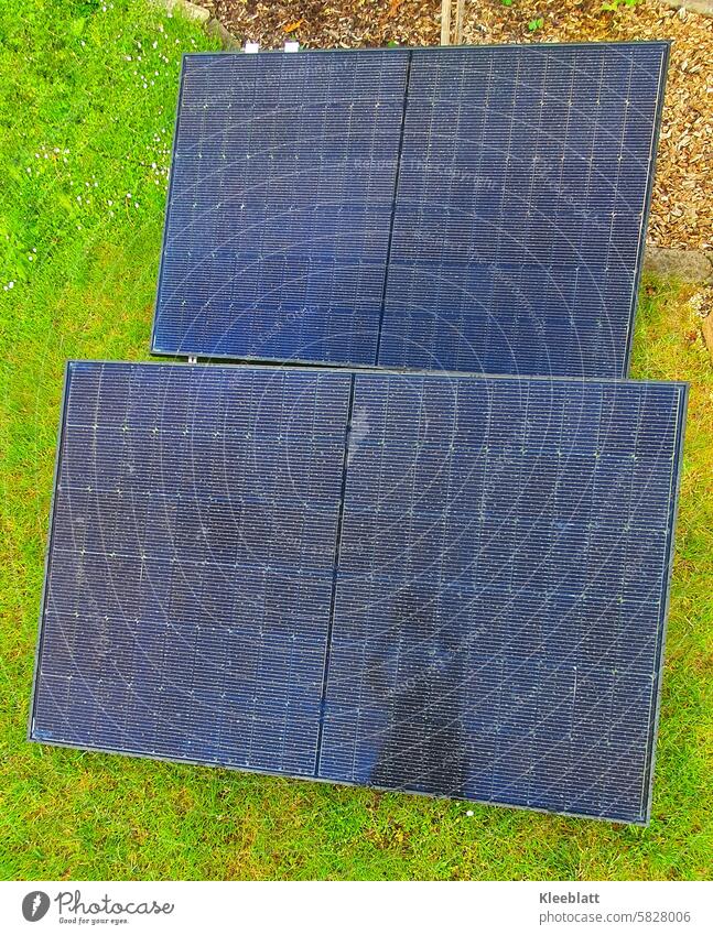 Two solar panels lying in the green grass - Green electricity - homemade - top view Solar collector Energy photovoltaics Technology Sun Alternative Electric