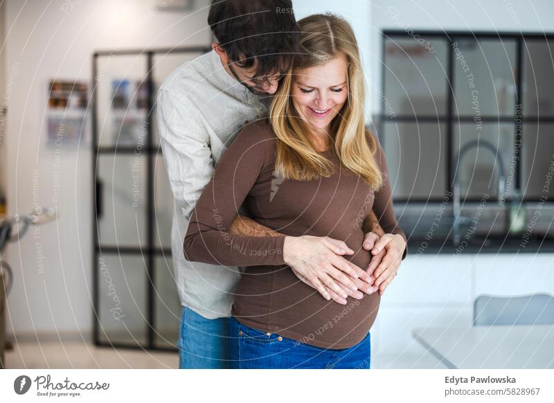 Portrait of a loving couple expecting a baby pregnancy pregnant adult anticipation awaiting belly birth body care caucasian child expectant expectation family
