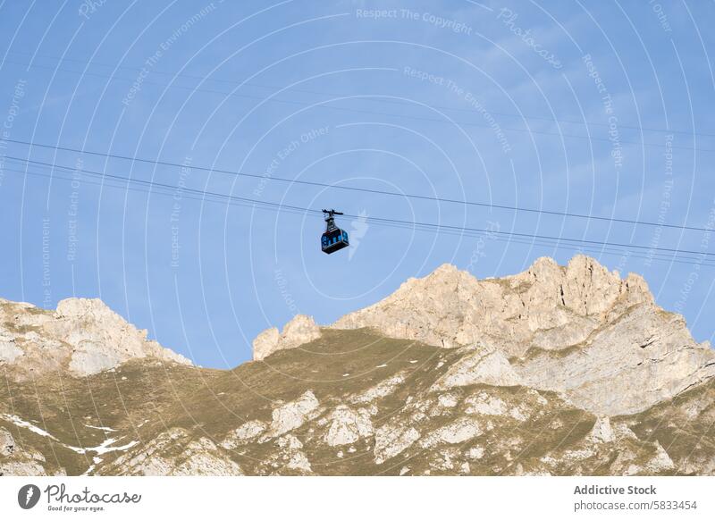 Cable car ascending rugged mountains in Valle de Liebana cable car valle de liebana cantabria spain picos de europa sky blue peak transport high glide clear