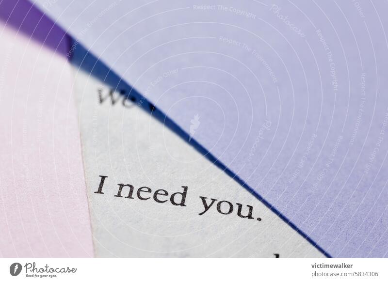 Book page with words detail book background concept I NEED YOU studio shot copy space pink color couple relationship love emotion romantic purple color macro