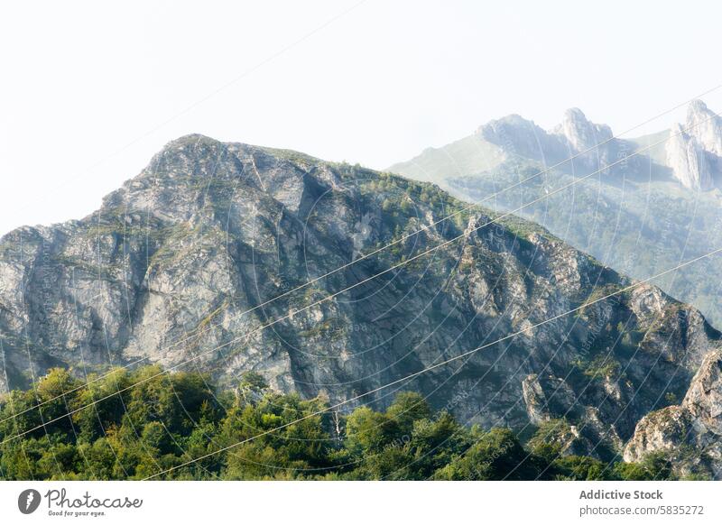 Power lines against the Magina Mountain Range vista mountain magina range peak sky bright power rugged electricity cable wire transmission energy infrastructure