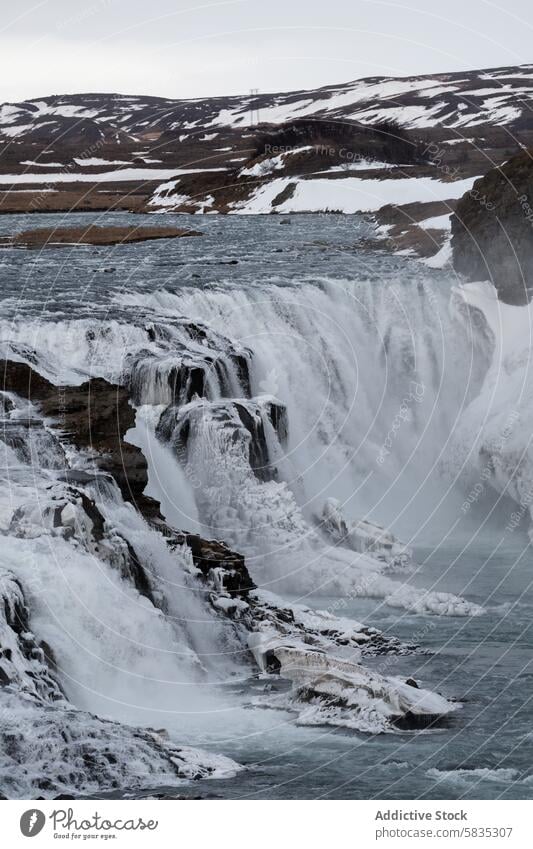 Majestic frozen waterfall in Iceland rough landscape iceland winter nature icy flow rocky terrain cliff cascade snow cold outdoor scenic natural beauty