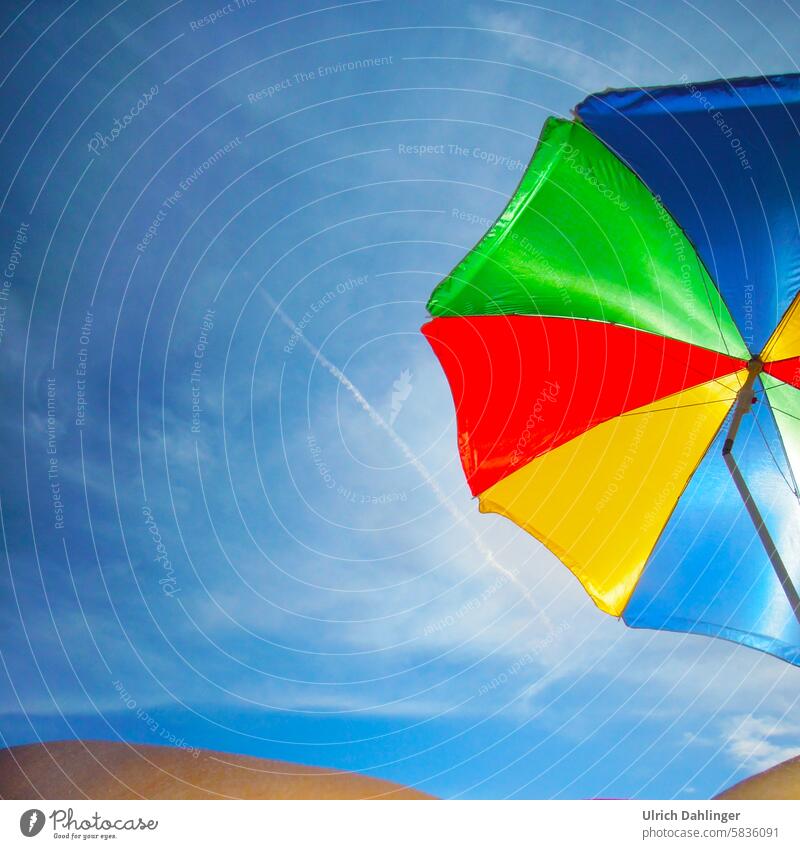 sunshade in different colors in front of an intense blue sky, with a person at the lower edge of the picture Summer Sun Shadow Beach Sky vacation holidays