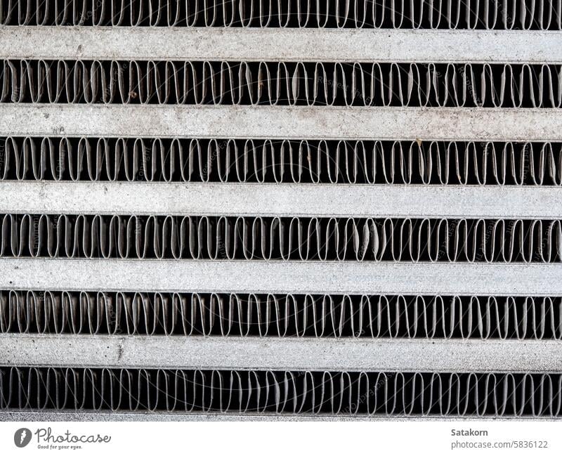 The metal grill of a car radiator is old and has scale marks texture cooling part vehicle grunge detail automotive white engine background equipment