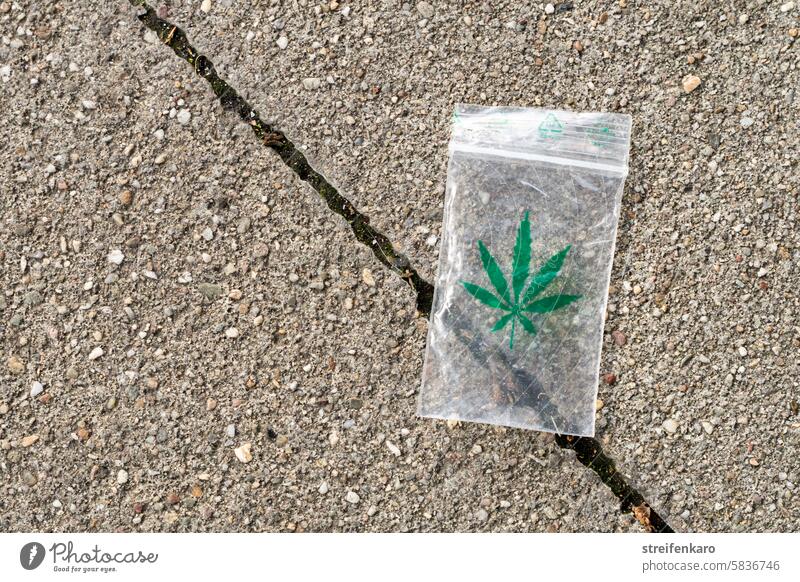 A sachet? Cannabis Marijuana drugs soft drugs Drug addiction Addiction Intoxicant Grass narcotic Hemp Intoxication Medication thc Packaging Street Pavement