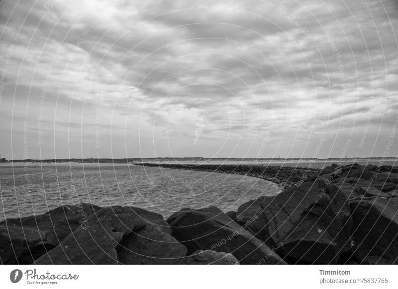 North Sea sky with pier Mole stones Fastening Protection Water Ocean Sky Clouds Weather Denmark coast Deserted Vacation & Travel Black & white photo