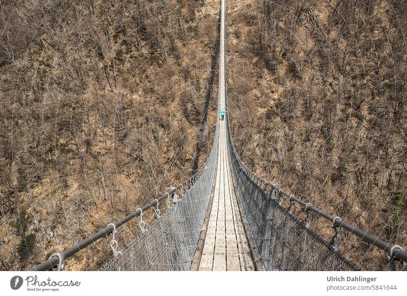 Tibetan suspension bridge from the crossing perspective with a person on the bridge Suspension bridge Tibetan bridge pedestrian bridge Bridge Architecture Brave