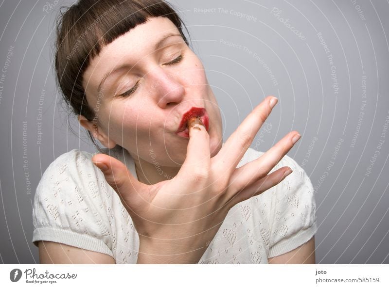Woman licking chocolate from her finger with relish Candy Chocolate Nutrition Eating Well-being Contentment Senses Feminine Young woman Youth (Young adults)