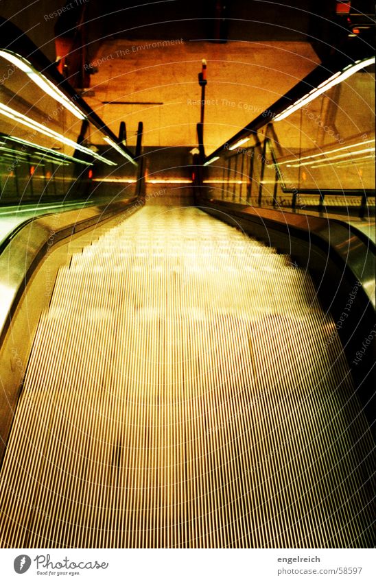 Escalator at the subway Driving Downward Night Moody Cold Light Underground Potsdamer Platz Movement