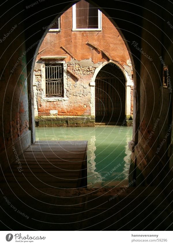 Backyard in Venice Waterway Lagoon Turquoise Archway Italy Tunnel Historic Shadow Tunnel vision Vista Old Historic Buildings Deserted Jetty Decline Channel