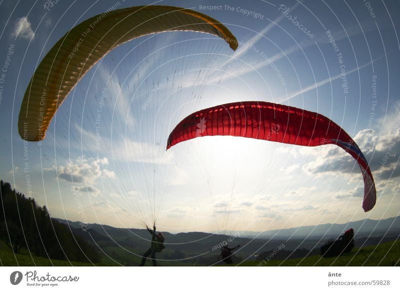 paraglider session IV 2 Red Yellow Dazzle Moody Clouds Paraglider Paragliding Fisheye Flashy Joy Extreme sports Aviation Couple Sky Sun Freedom Bright Beginning
