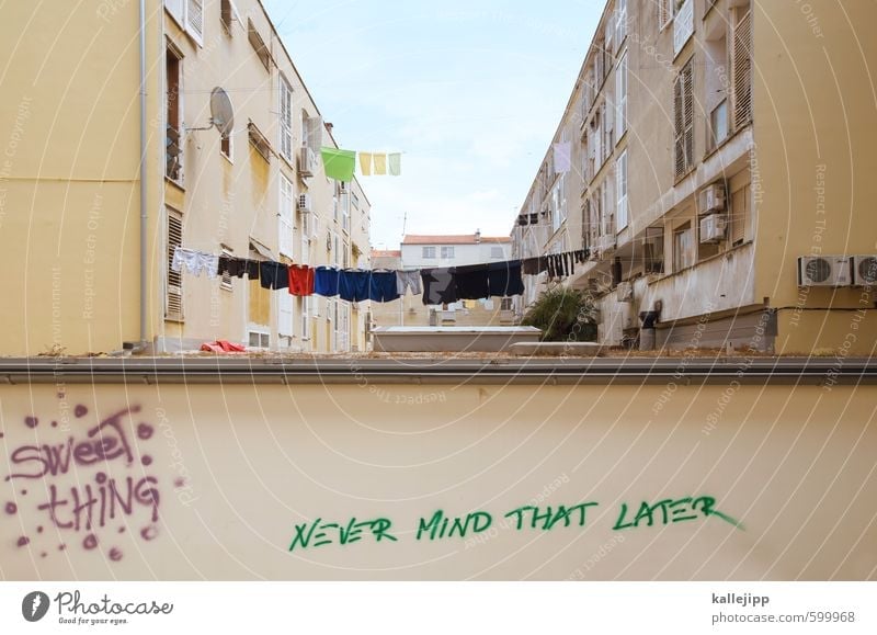 never mind ... Town House (Residential Structure) Building Architecture Wall (barrier) Wall (building) Facade Balcony Characters Graffiti Creativity Clothesline