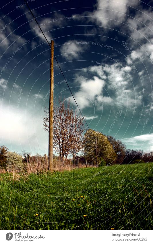 on a wire Electricity pylon Countries Clouds Grass Meadow Sky country Landscape