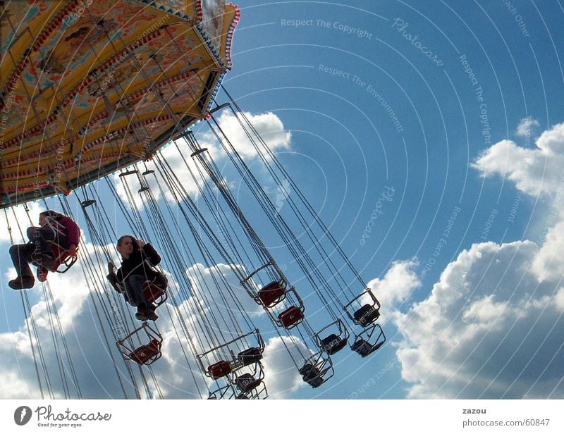 on the merry-go-round Carousel Oktoberfest Fairs & Carnivals Girl Child Showman Clouds Recklessness Hover Feasts & Celebrations Joy Sky care Freedom