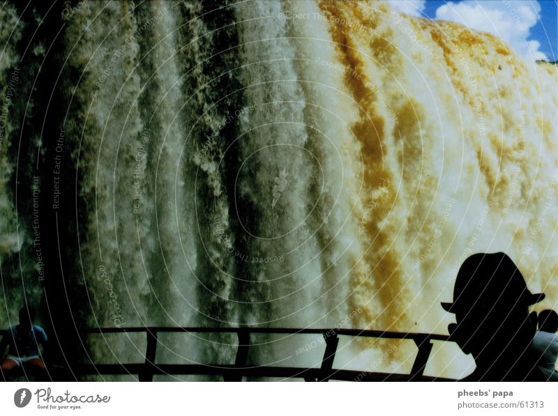 Iguazú Electricity Silhouette Might Clouds Water Waterfall River Iguazu Falls paraguay Hat Human being Shadow Handrail Bridge Large Sky Blue